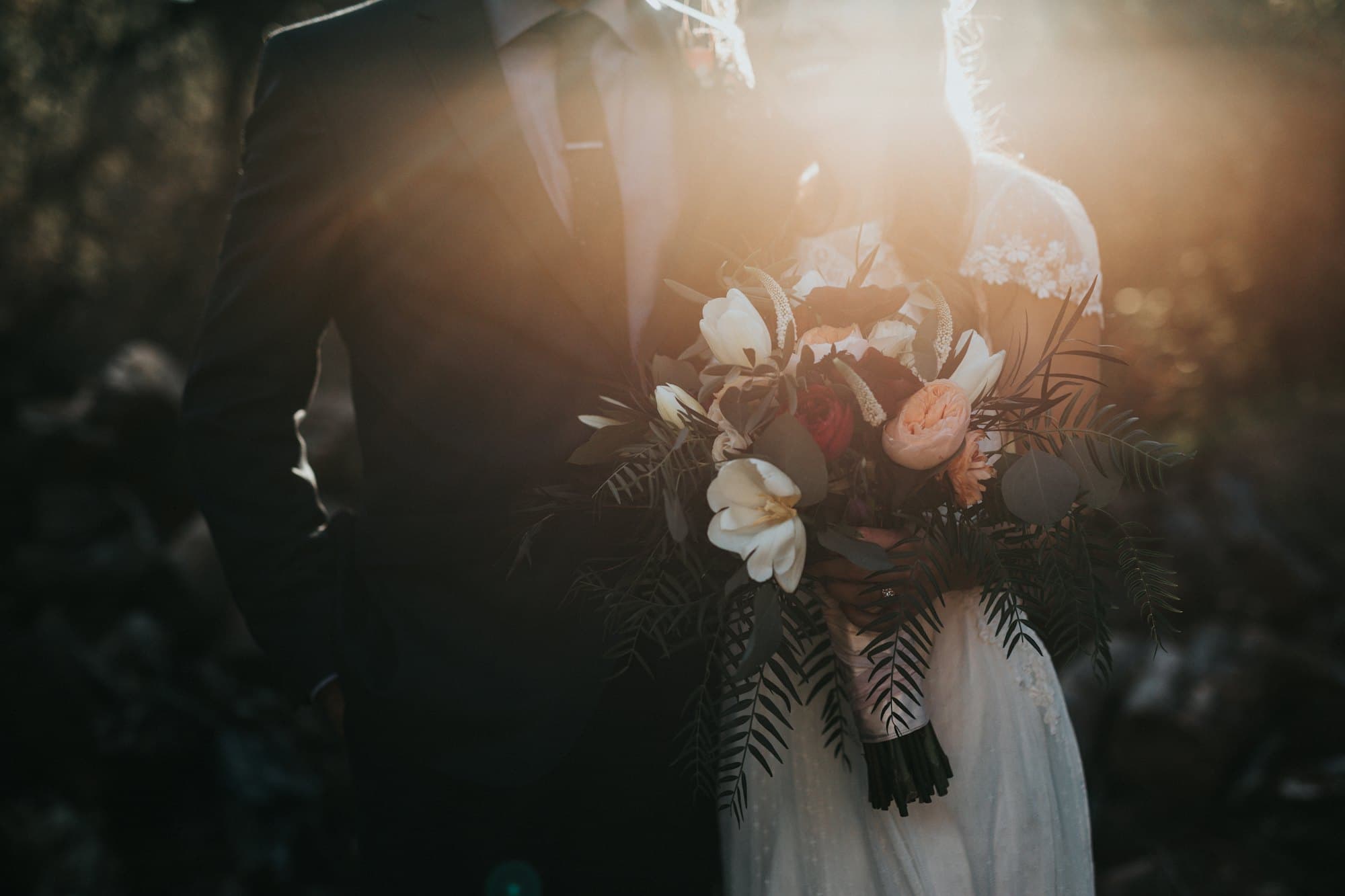 Couple at sunset, hands joined, soft natural light